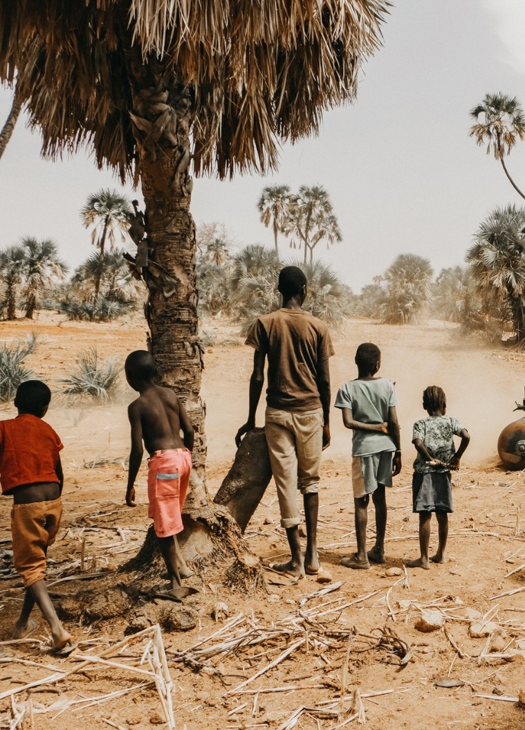 Man and children outside in Sudan